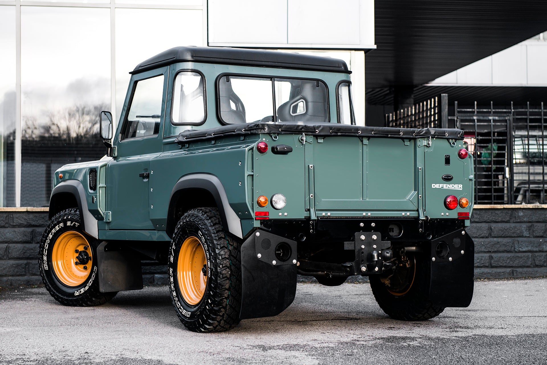 VIEW FROM THE SHOWROOM: LAND ROVER DEFENDER 90 PICK UP CHELSEA WIDE TRACK THE KESWICK GREEN